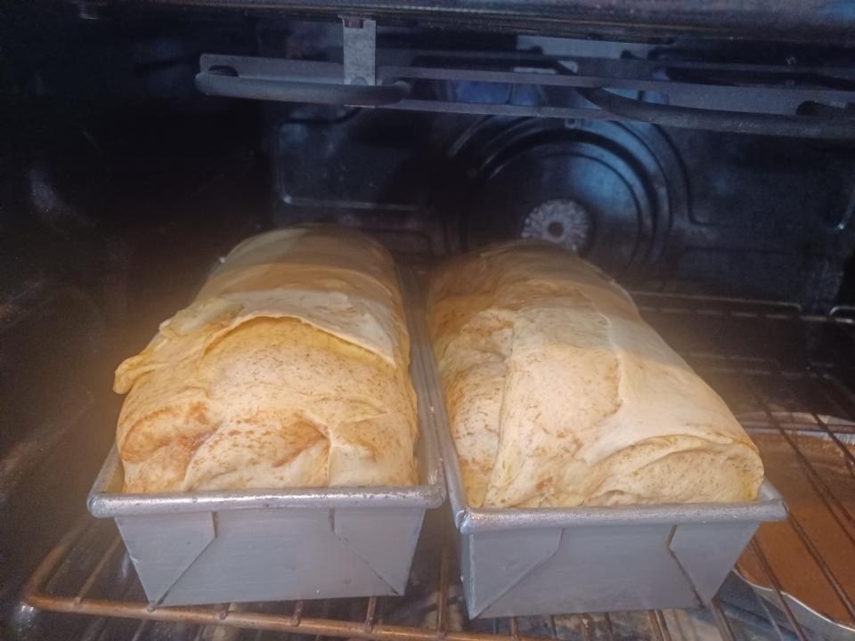 Loaves of cinnamon roll bread baking in the oven