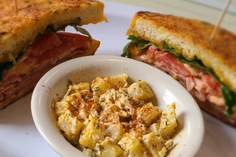 The ham and cheddar melt on garlic parmesan crusted bread, with a bowl of homemade potato salad